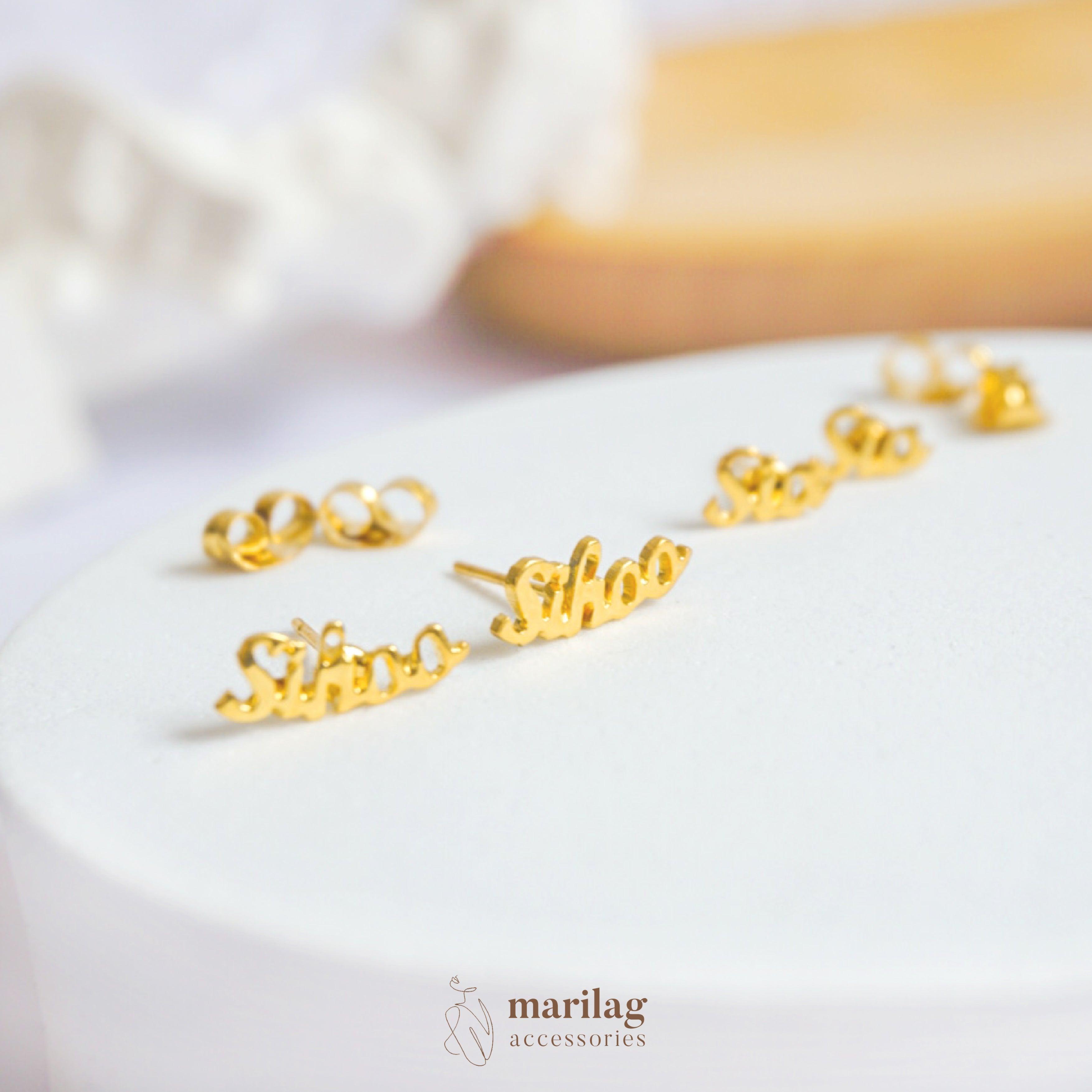 Gold name earrings in script font